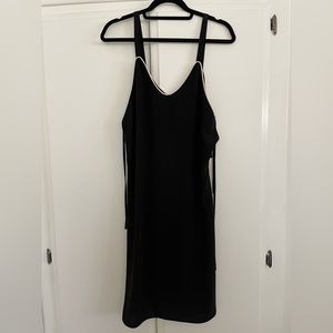 Lumiere black dress with straps and small side cut outs. Size small